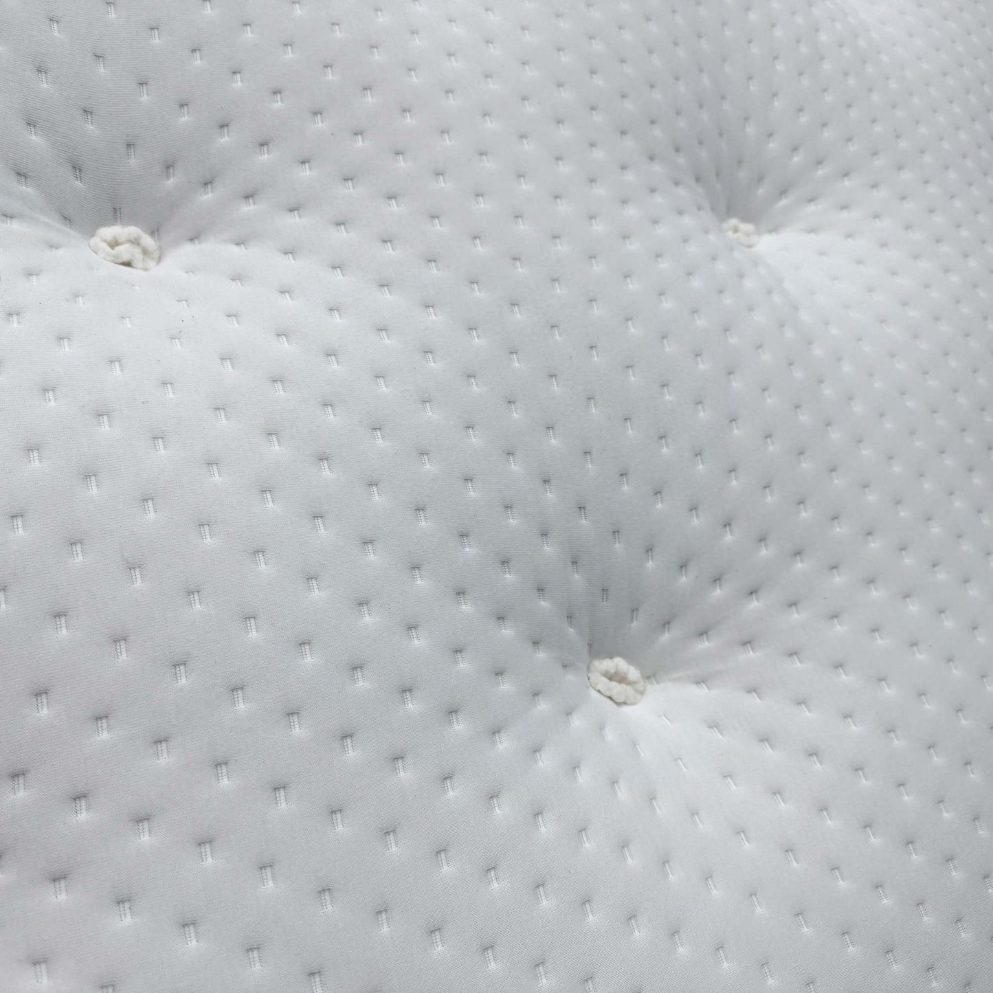 Close-up of the natural damask cover, highlighting the traditional deep button tufting and the soft-touch textured fabric.