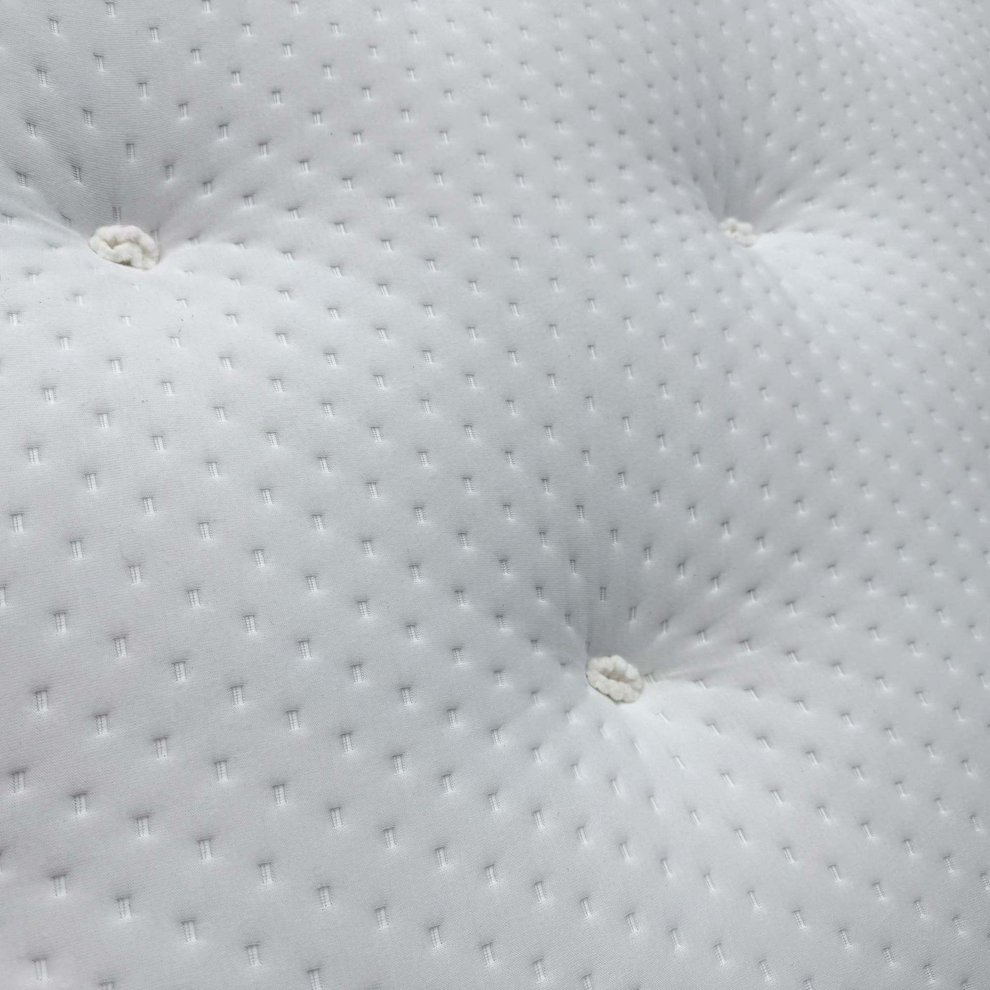 Close-up of the natural damask cover, highlighting the traditional deep button tufting and the soft-touch textured fabric.