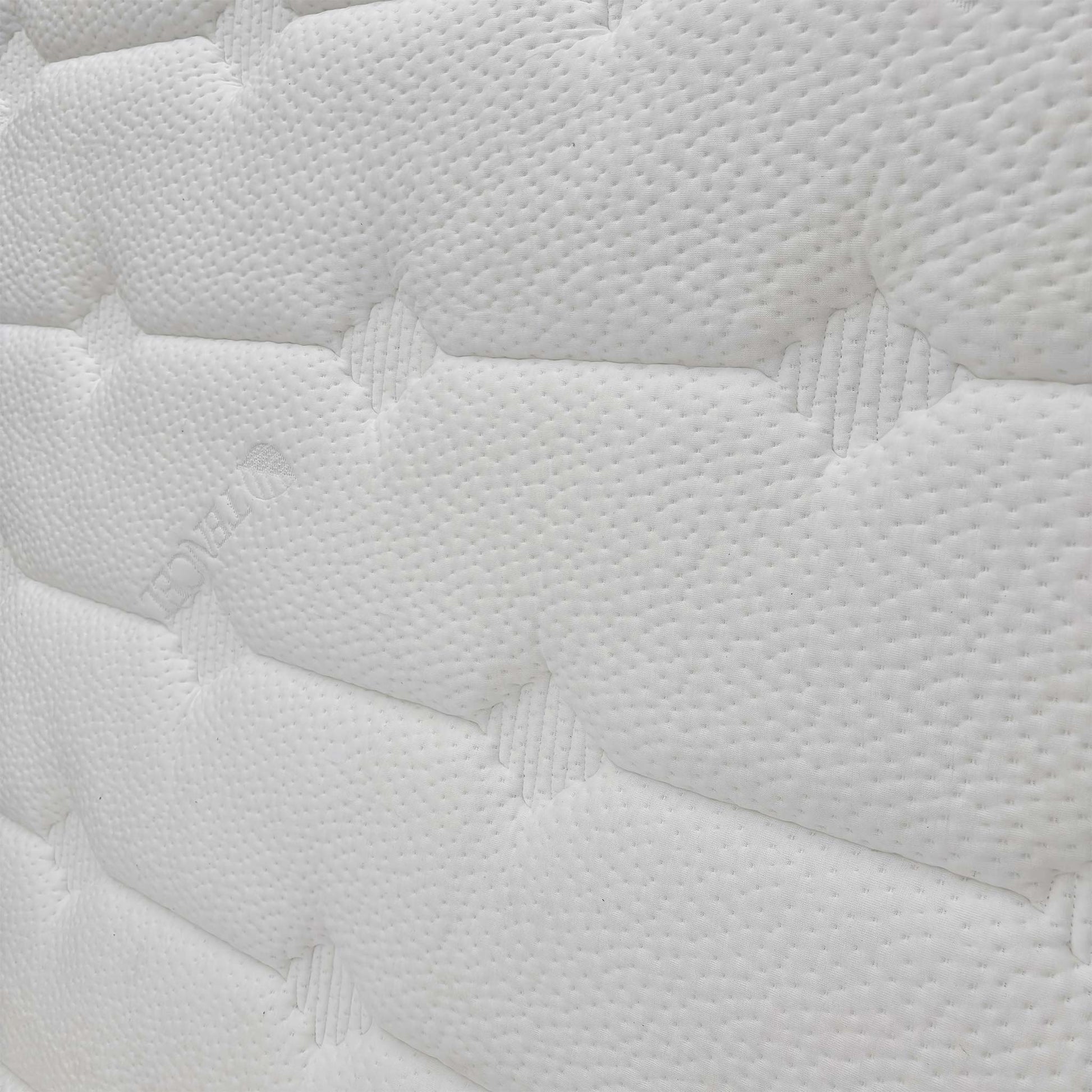 Close-up of the mattress surface texture, highlighting the breathable eco-friendly fabric and quilted patterns.