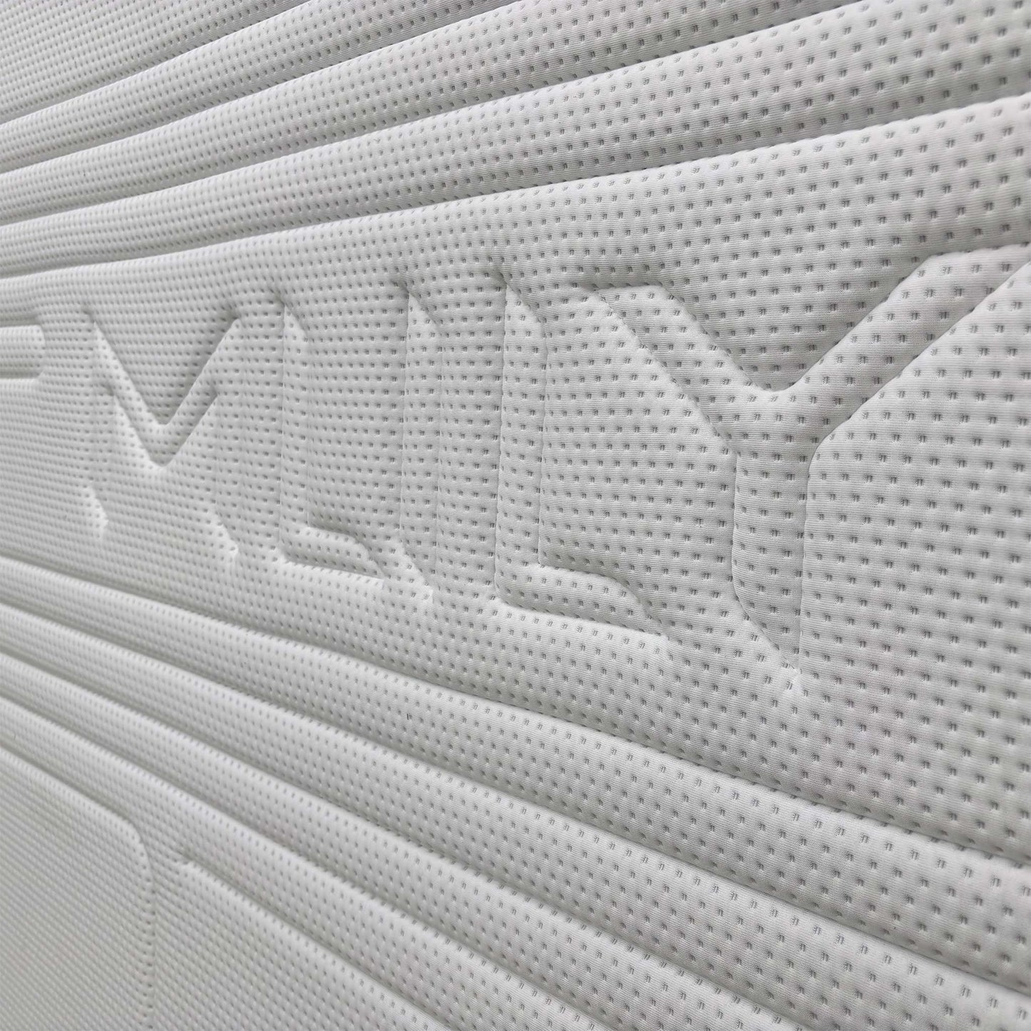 Close-up of the breathable white and grey knitted fabric cover of the Mlily Hybrid Gel 5000 Mattress.