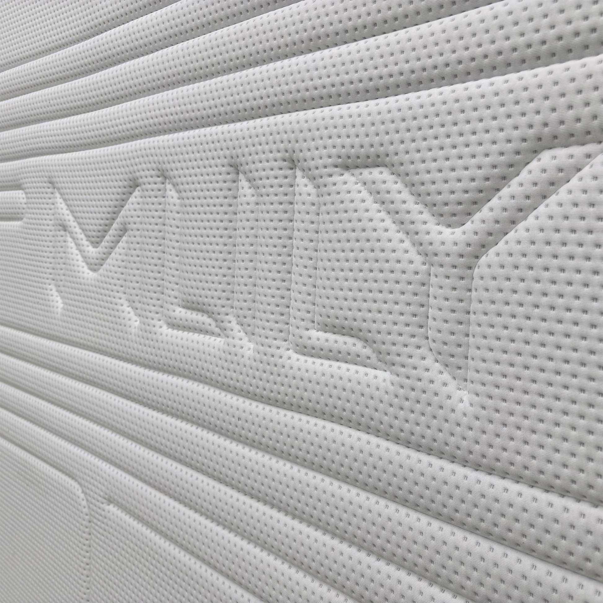 Close-up of the breathable white and grey knitted fabric cover of the Mlily Hybrid Gel 5000 Mattress.