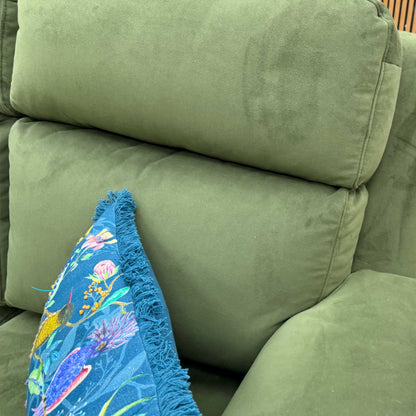 Angled close-up view of the sofa, highlighting the texture and color of the Plush Vine Green velvet upholstery.