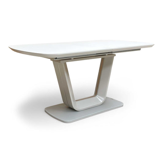 Front view of the 'Stockholm' 160cm dining table, showing the reflective light grey glass top and matching high-gloss pedestal base.