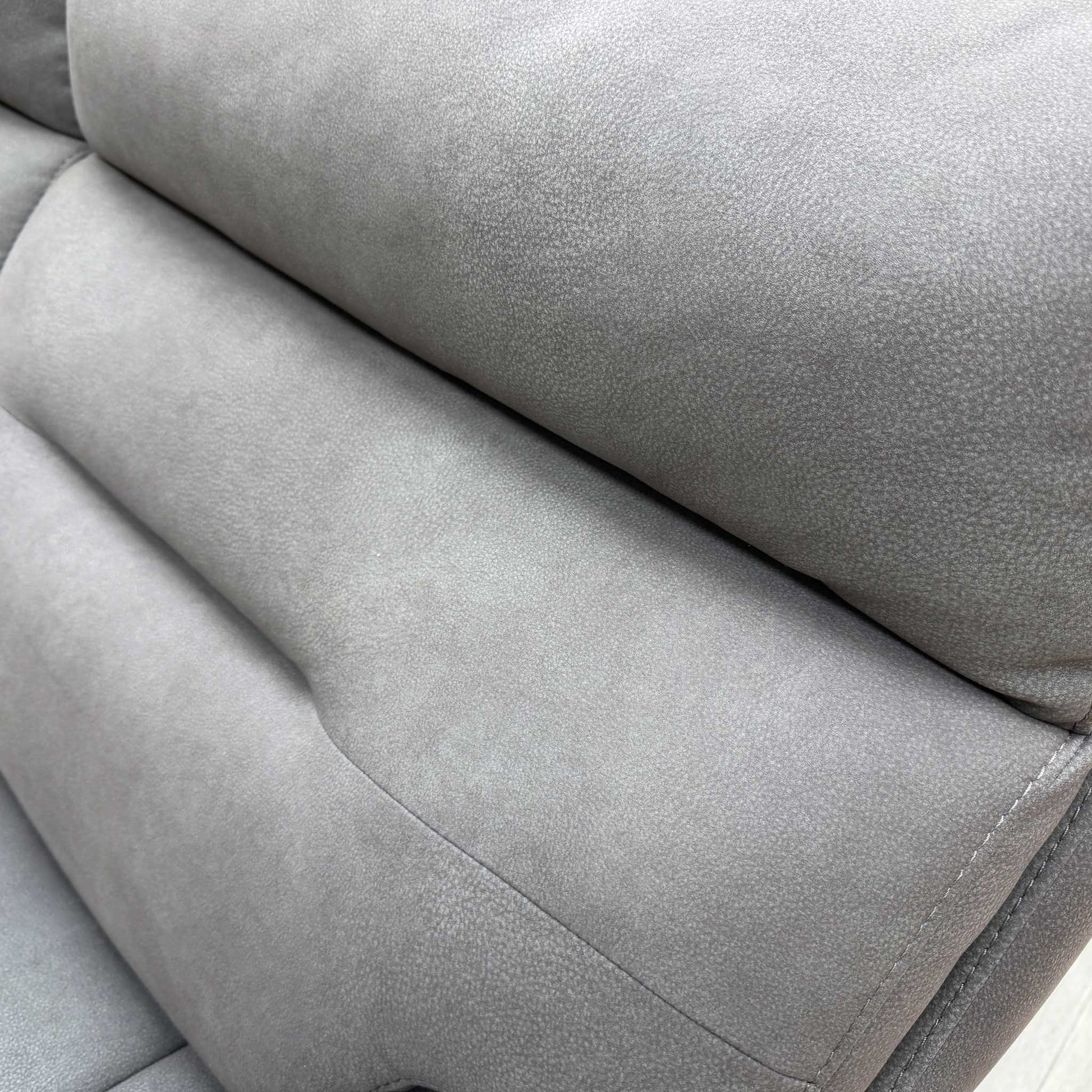 Close-up shot detailing the construction and stitching of the Nappa Grey fabric upholstery.