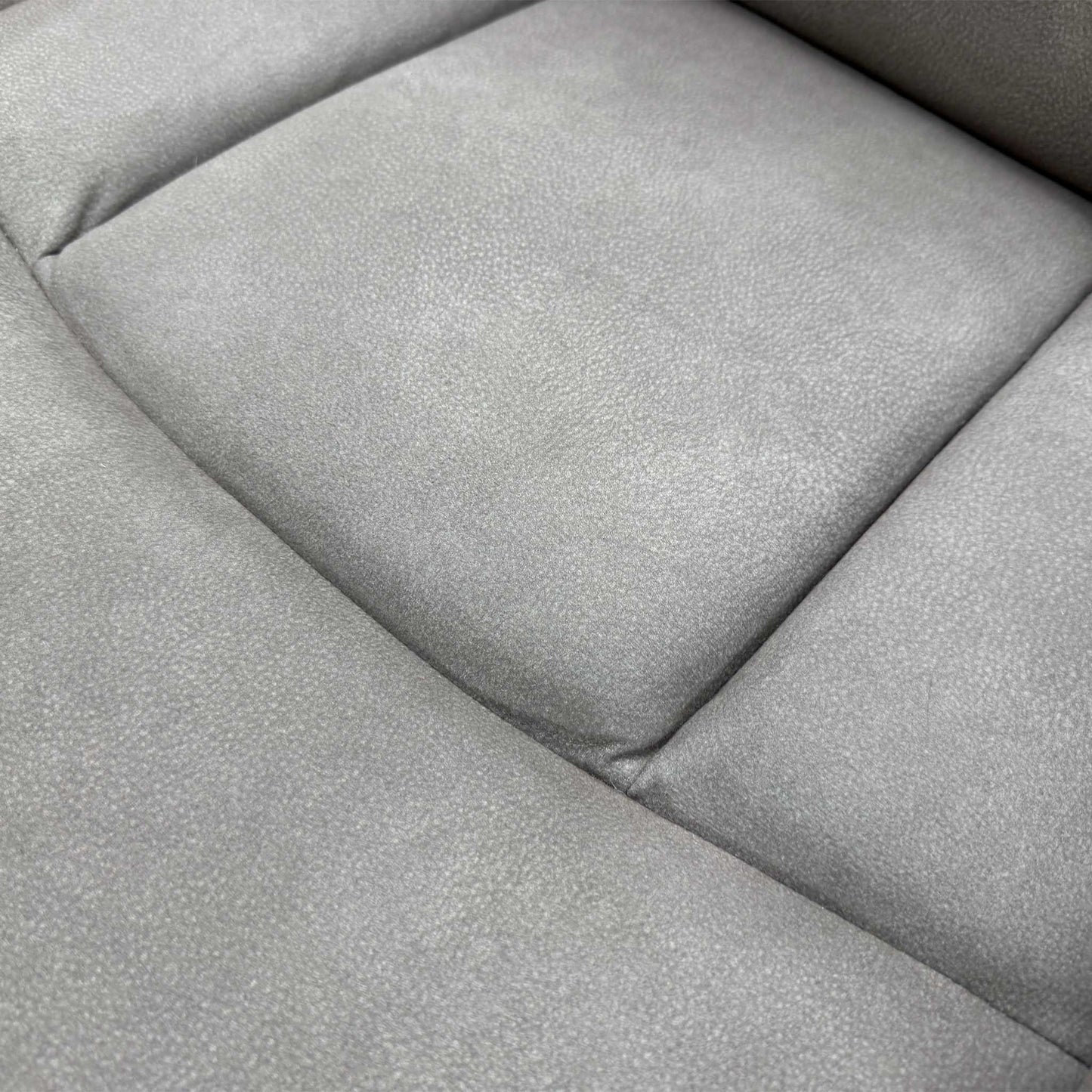 Close-up shot detailing the construction and stitching of the Nappa Grey fabric upholstery.