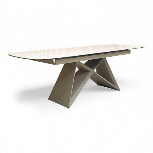 Angled view of the Mirage Ceramic Top Pop-Up 180cm Dining Table with its ceramic surface and modern base.