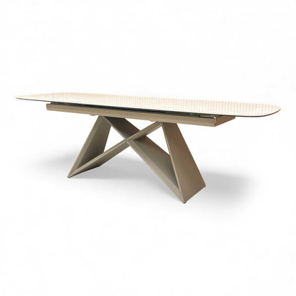Side view of the table, focusing on the architectural, powder-coated base and the edge of the ceramic top.