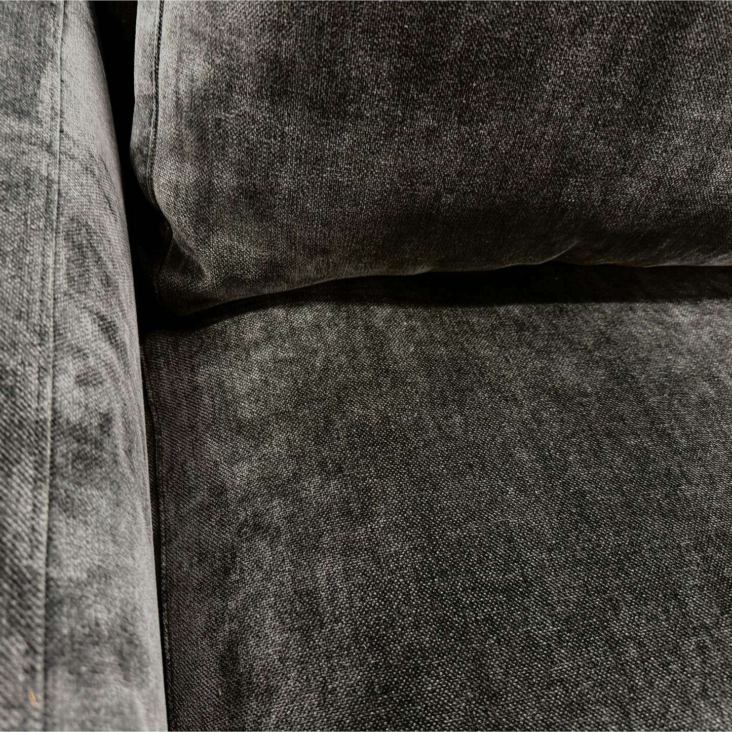 Angled close-up of the Swoon 'Denver' sofa, highlighting the texture of the charcoal grey linen fabric and the shape of the armrest.