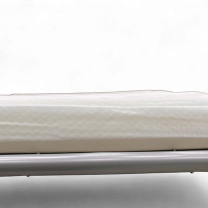 Detailed view of the square, ebony-colored wooden feet on the 'Esprit' Taupe Fabric Footstool.