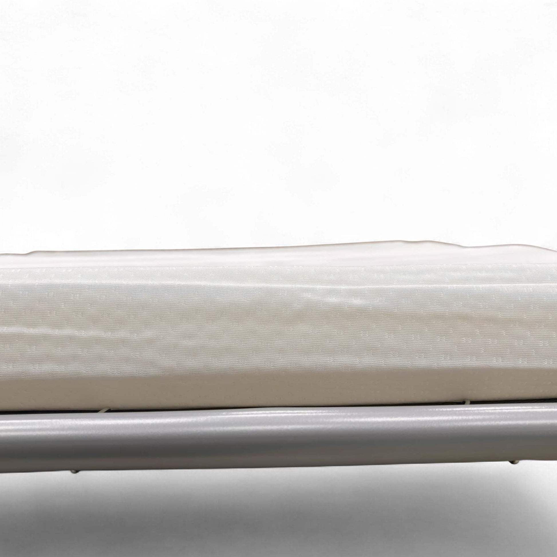 Close-up of the Ebony finish feet on the base of the footstool.