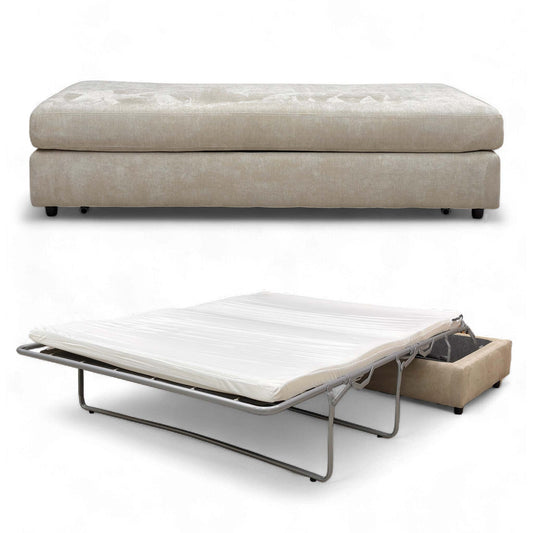 The footstool partially converted, showing the mattress starting to pull out.