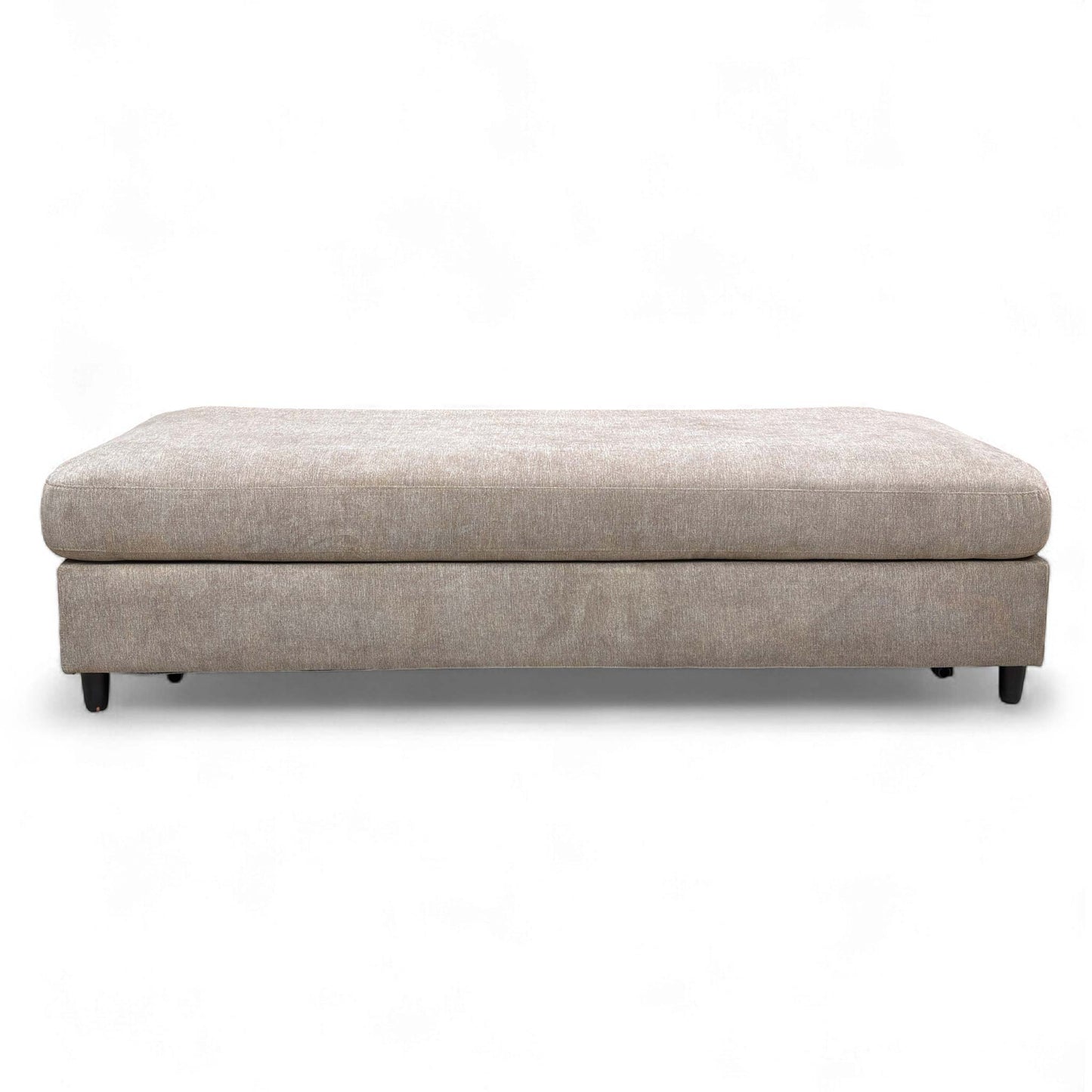 The footstool fully converted into a small double bed.