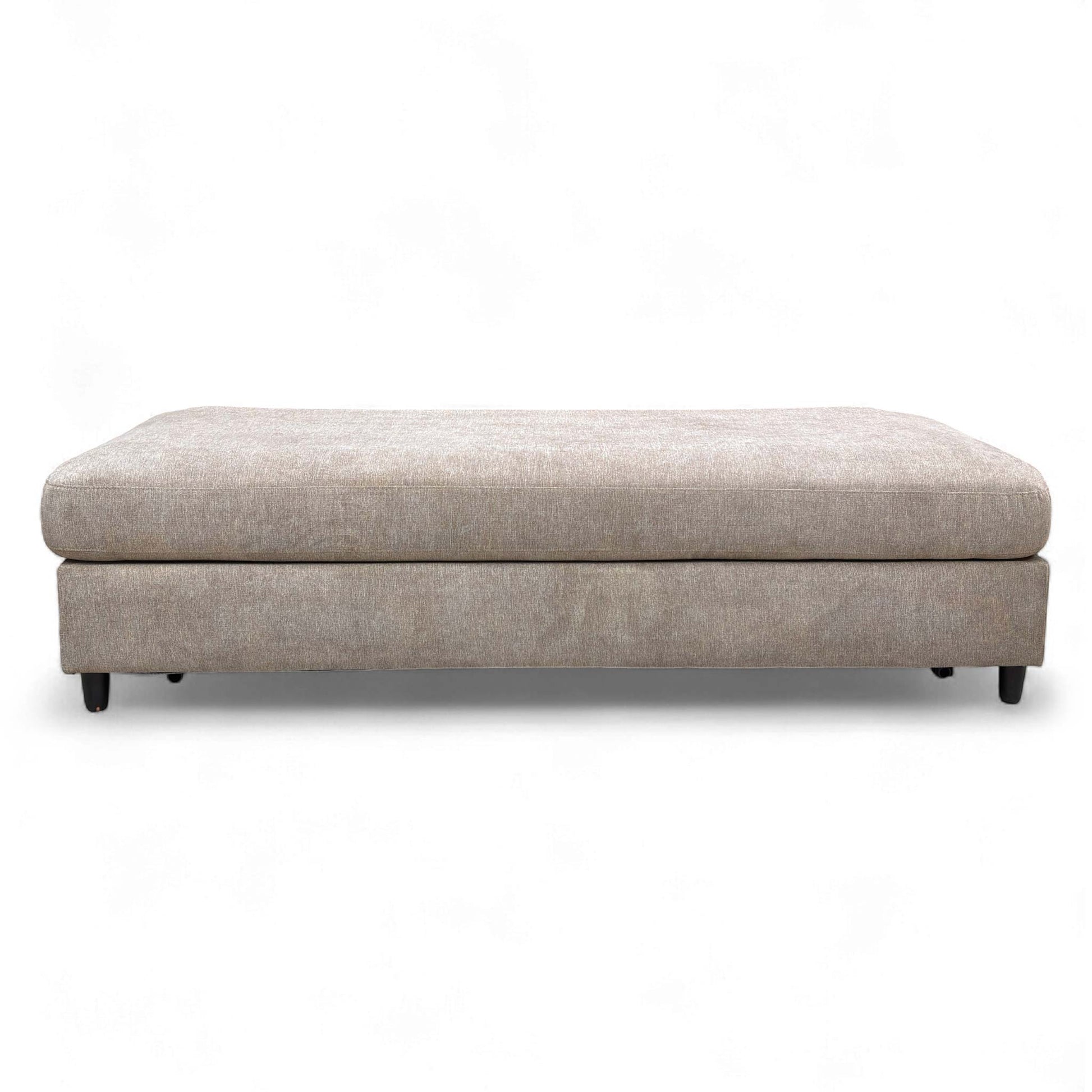 The footstool fully converted into a small double bed.