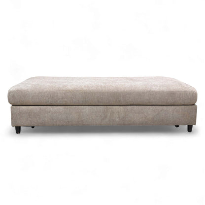 The footstool fully converted into a small double bed.