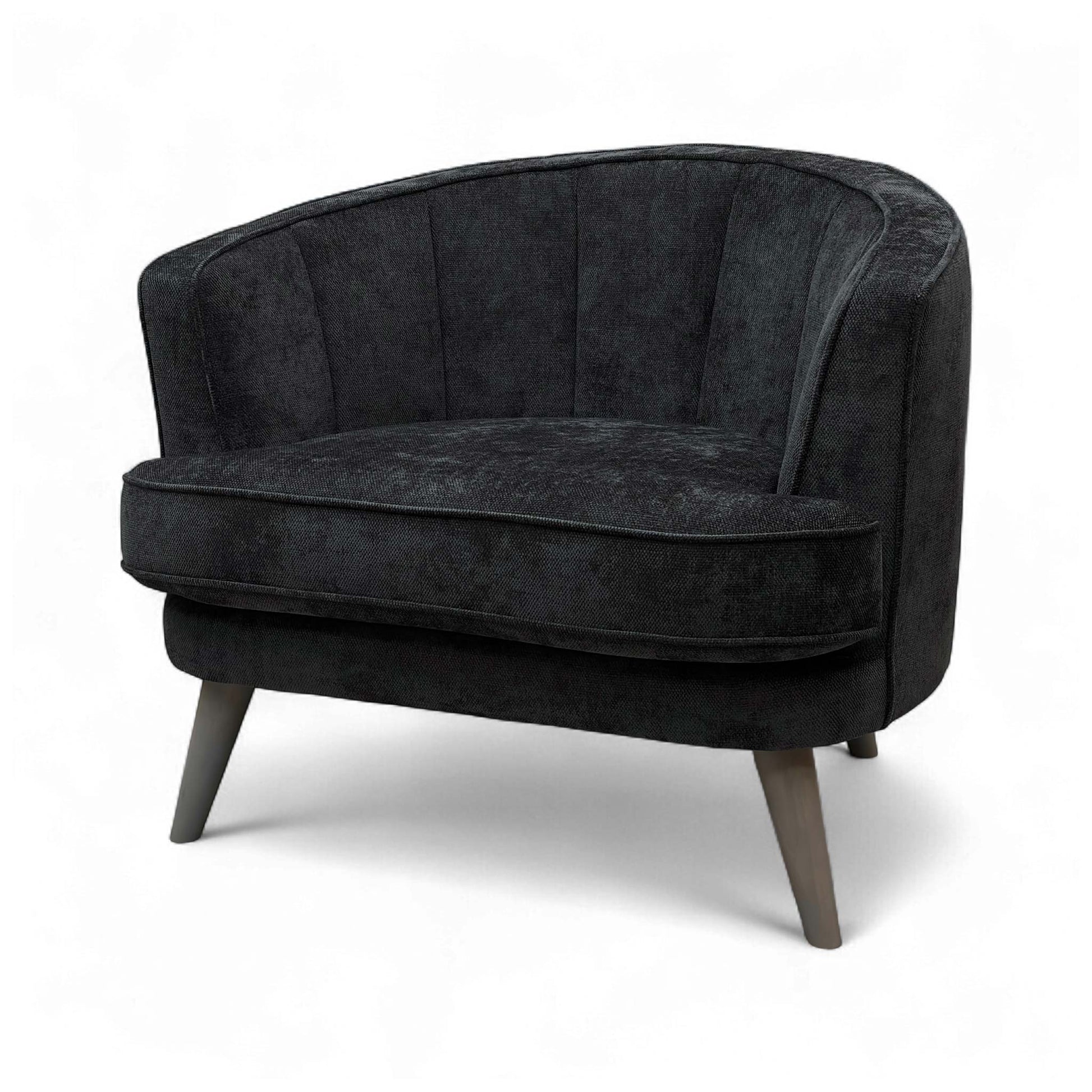 A view of the chair from a low angle, emphasizing the elegant tapered legs and the foam cushioning.