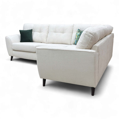 Angled view showing the back of the corner sofa, emphasizing the high back and overall robust shape.