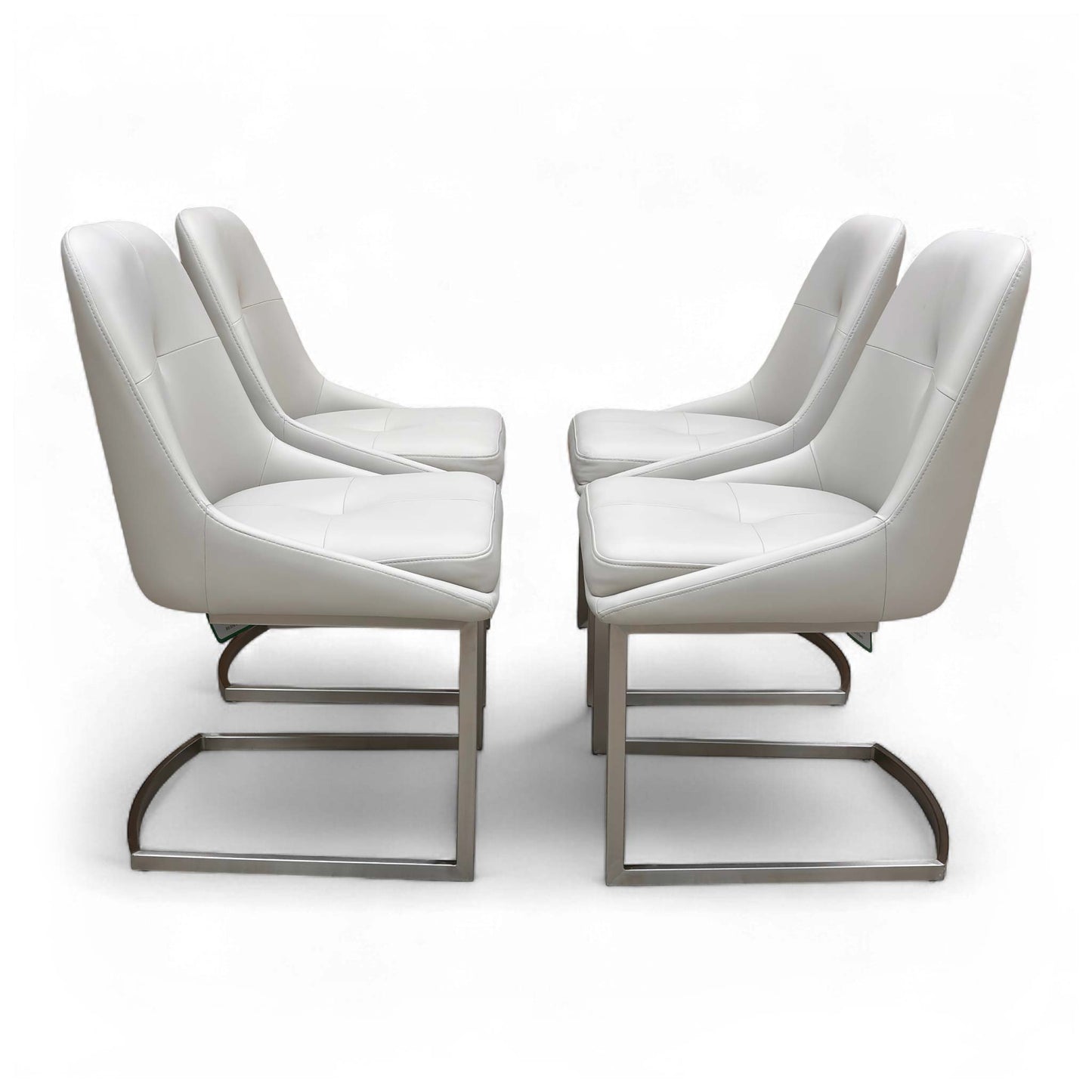 Side view of a single 'Avorio' Neutral Faux Leather Dining Chair, showing the shape of the seat and the curved metal cantilever base.