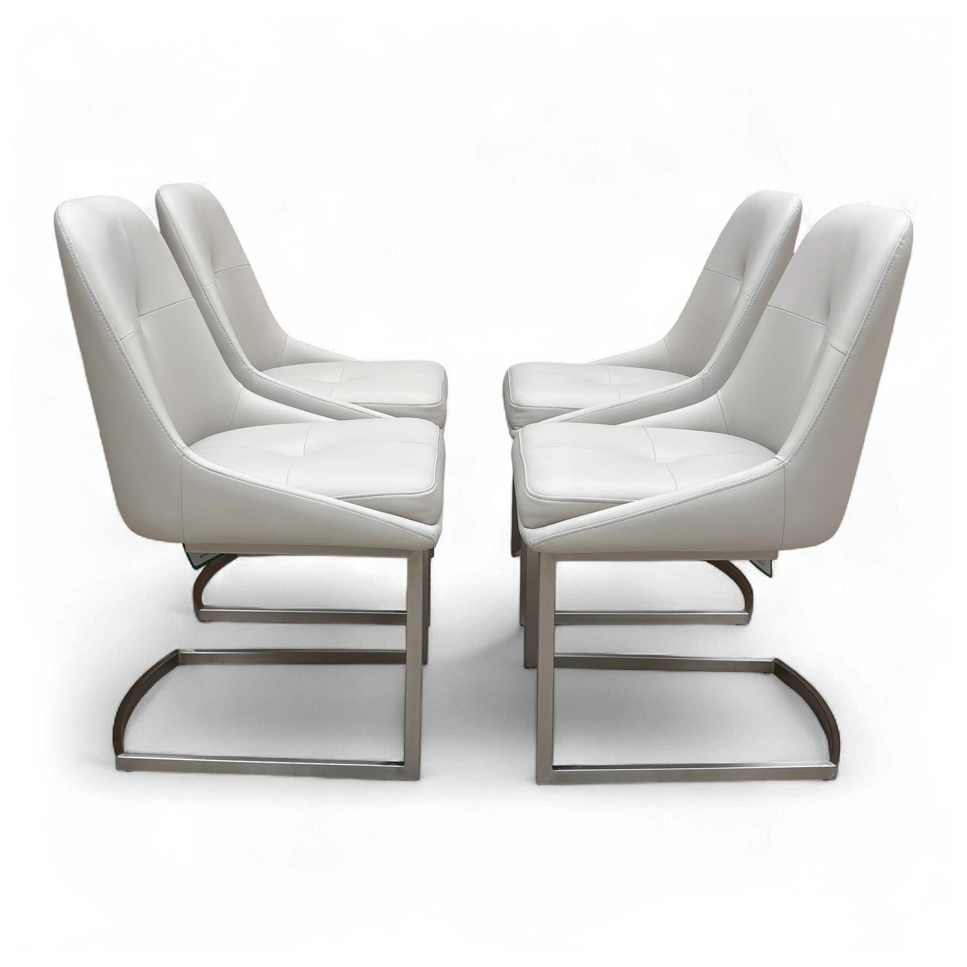 Side view of a single 'Avorio' Neutral Faux Leather Dining Chair, showing the shape of the seat and the curved metal cantilever base.