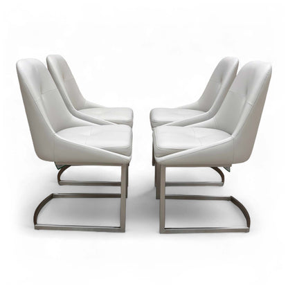 Side view of a single 'Avorio' Neutral Faux Leather Dining Chair, showing the shape of the seat and the curved metal cantilever base.