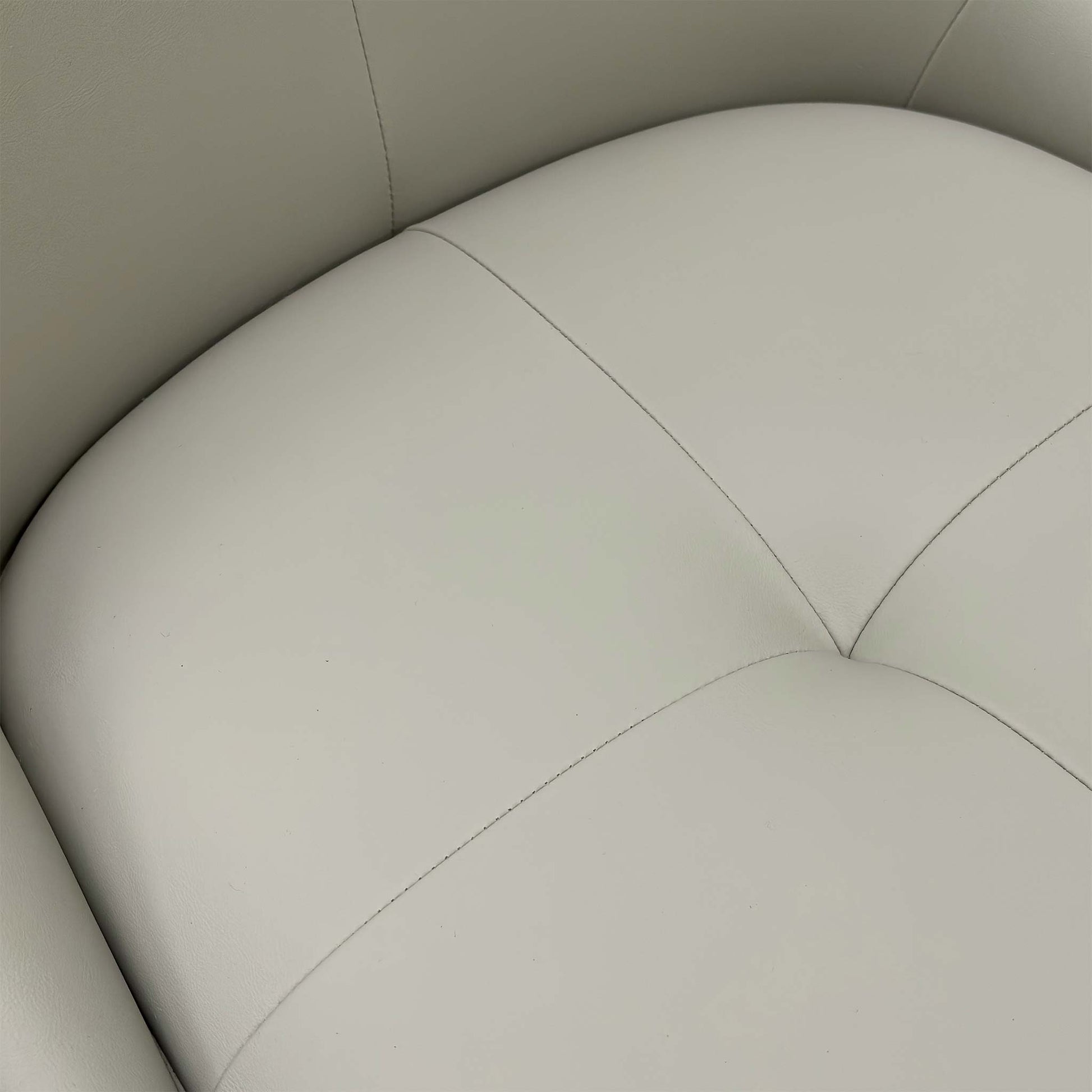 Close-up of two Avorio dining chairs, highlighting the padded seat, high back, and subtle horizontal stitching detail.