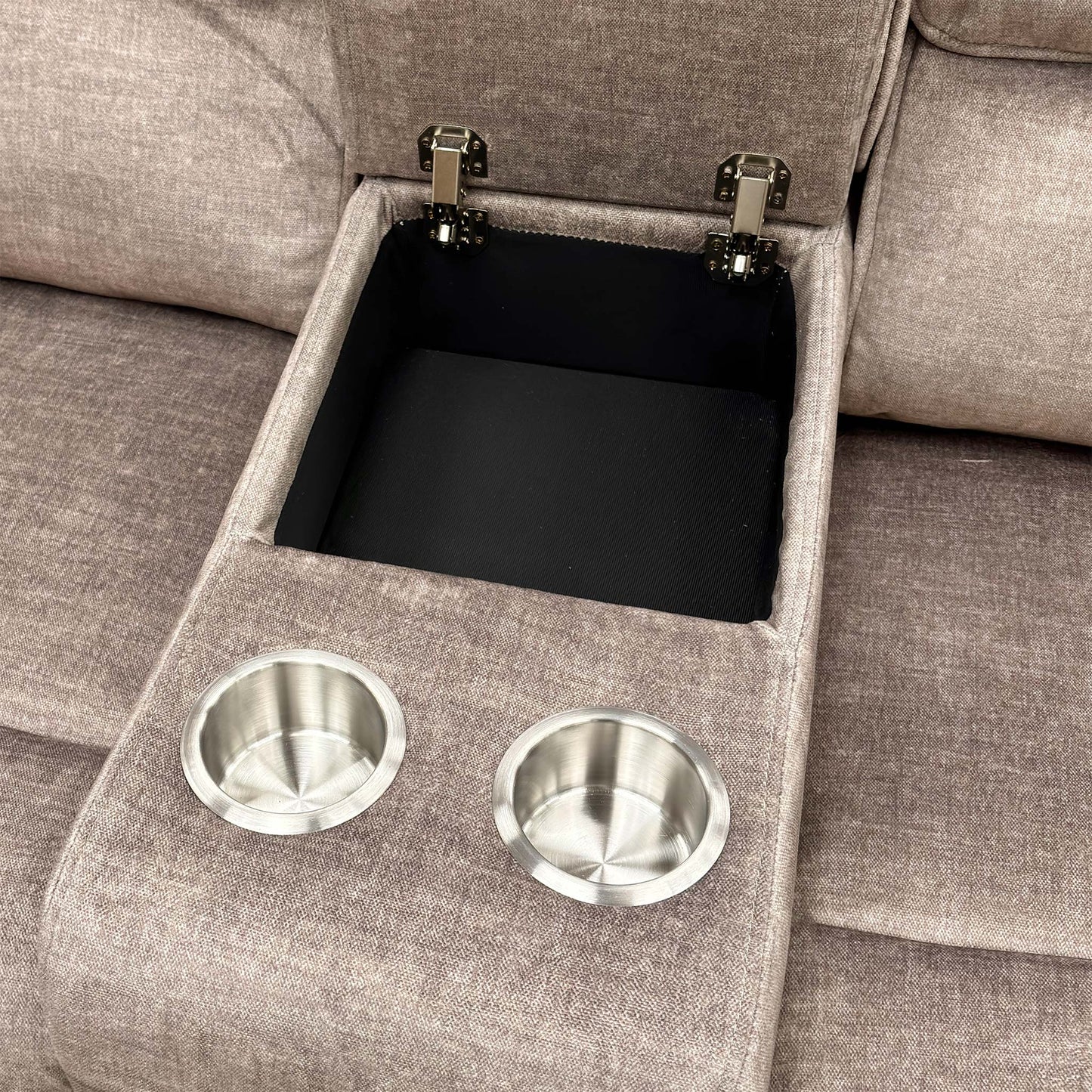 Close-up of the center console on the Savoy sofa, open to show the internal storage space and two cup holders.