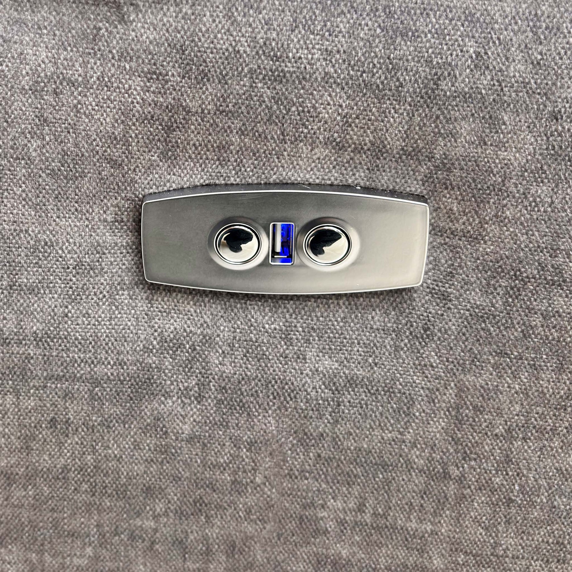 Close-up of the power recline control button located on the side of the armrest.