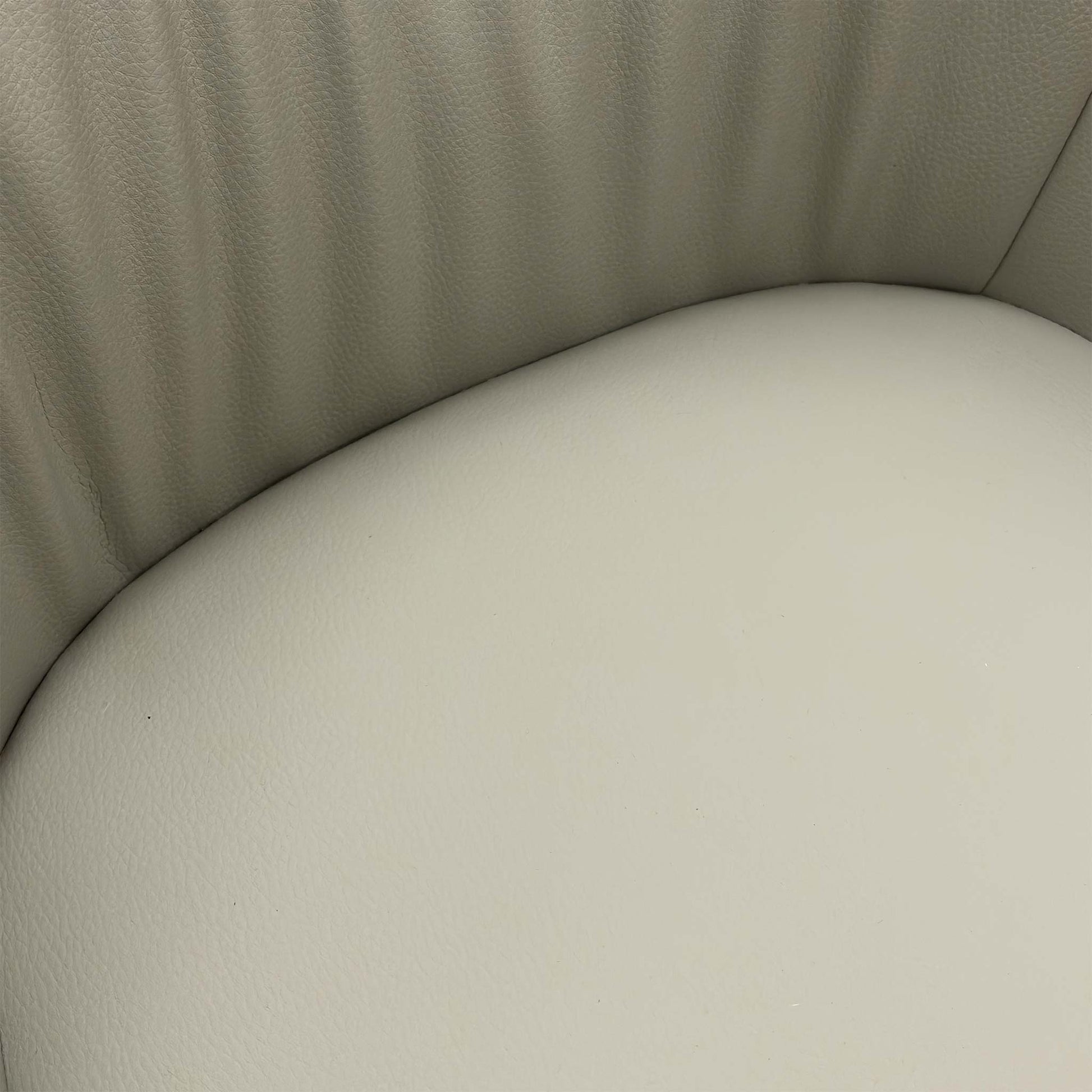 Close-up texture shot of the two-tone grey faux leather upholstery on the Portofino dining chair.