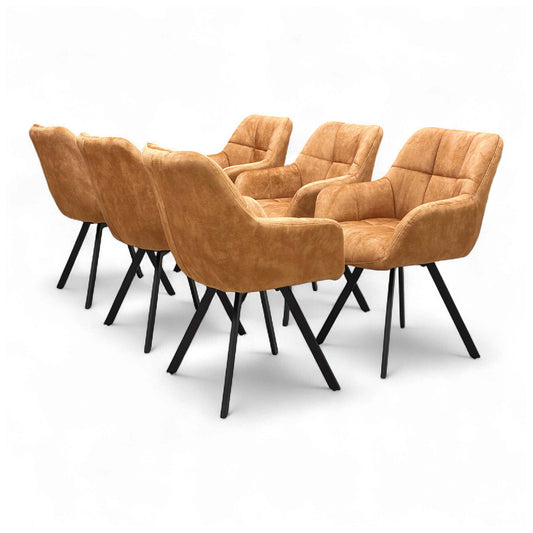 Angled view of the 'Jade' Rust Orange Velvet Swivel Dining Chair, showcasing its upholstered seat and black metal legs.