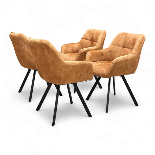 Angled view of the 'Jade' Rust Orange Velvet Swivel Dining Chair, showcasing its upholstered seat and black metal legs.