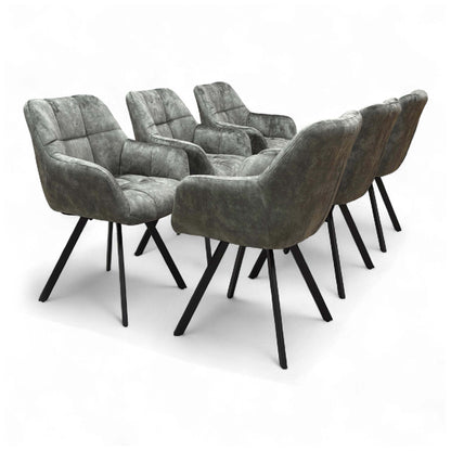 Angled view of the 'Jade' Olive Green Velvet Swivel Dining Chair, showcasing its upholstered seat and black metal legs.