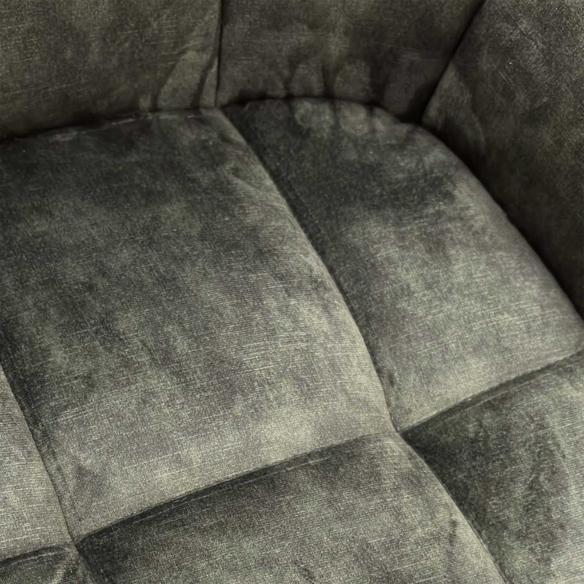 Close-up texture shot of the plush Olive Green Velvet upholstery on the 'Jade' Swivel Dining Chair.