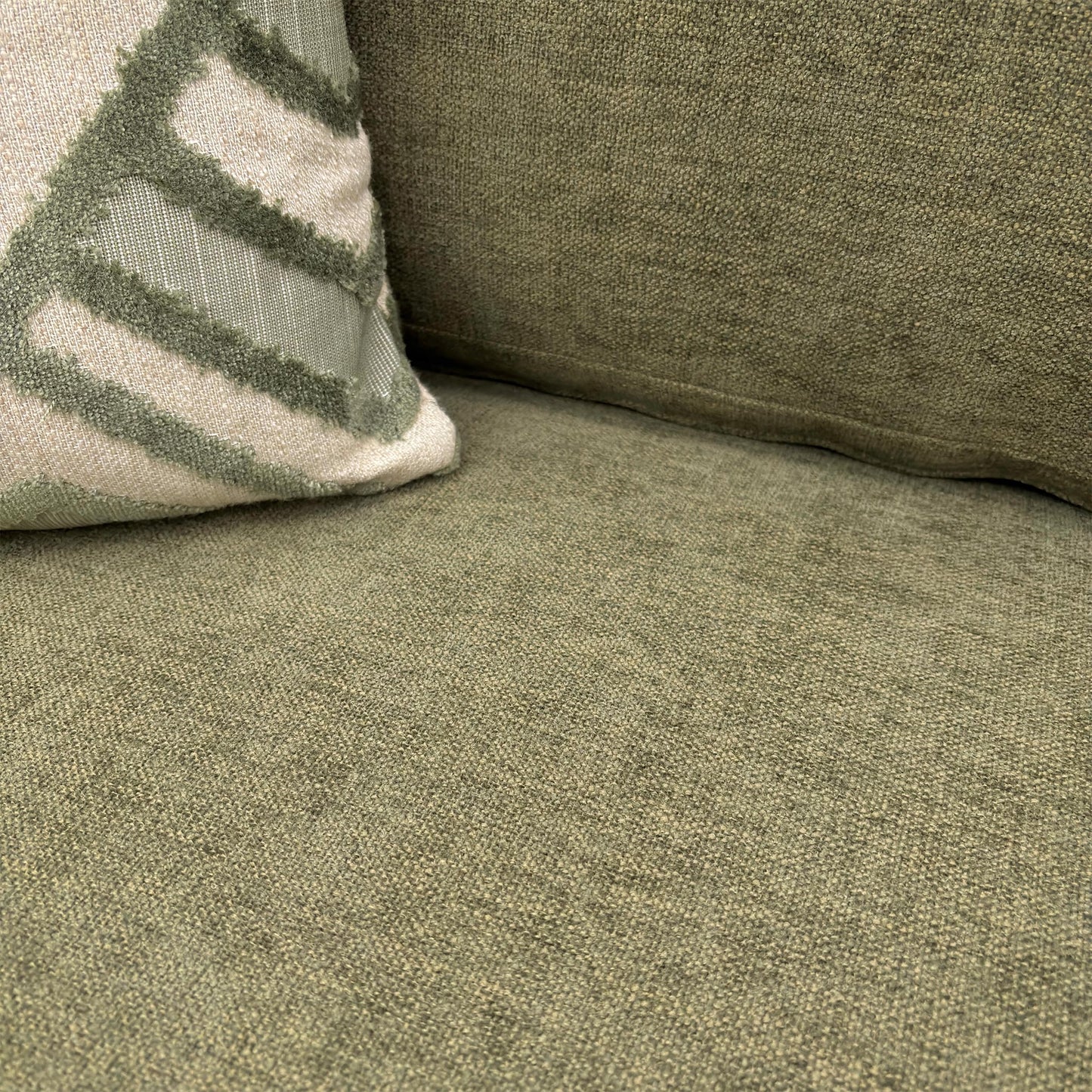 Close-up of the 'Jackson' Armchair in Fern Green Chenille, showcasing the deep cushioning, reversible seat cushion, and rounded arms.