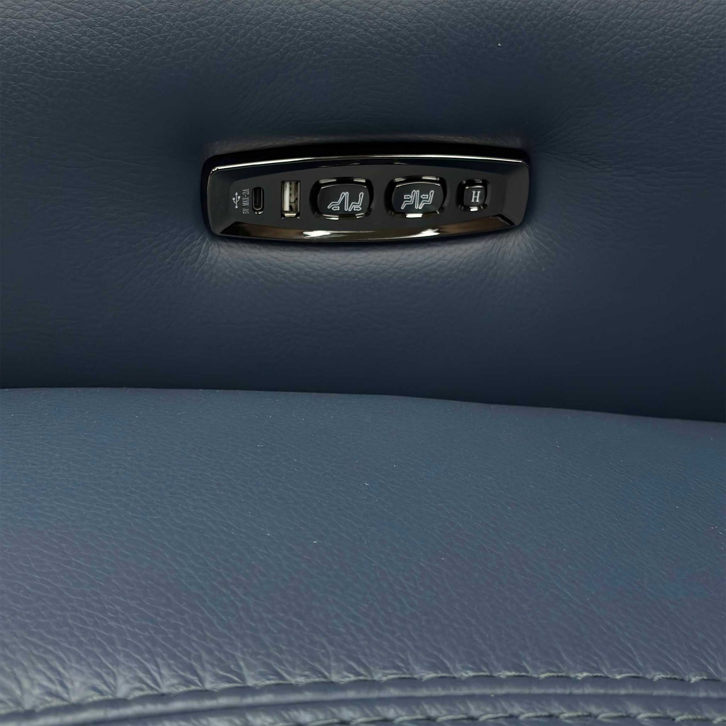 Close-up on the control panel button, likely showing the controls for the power recline and power headrest.
