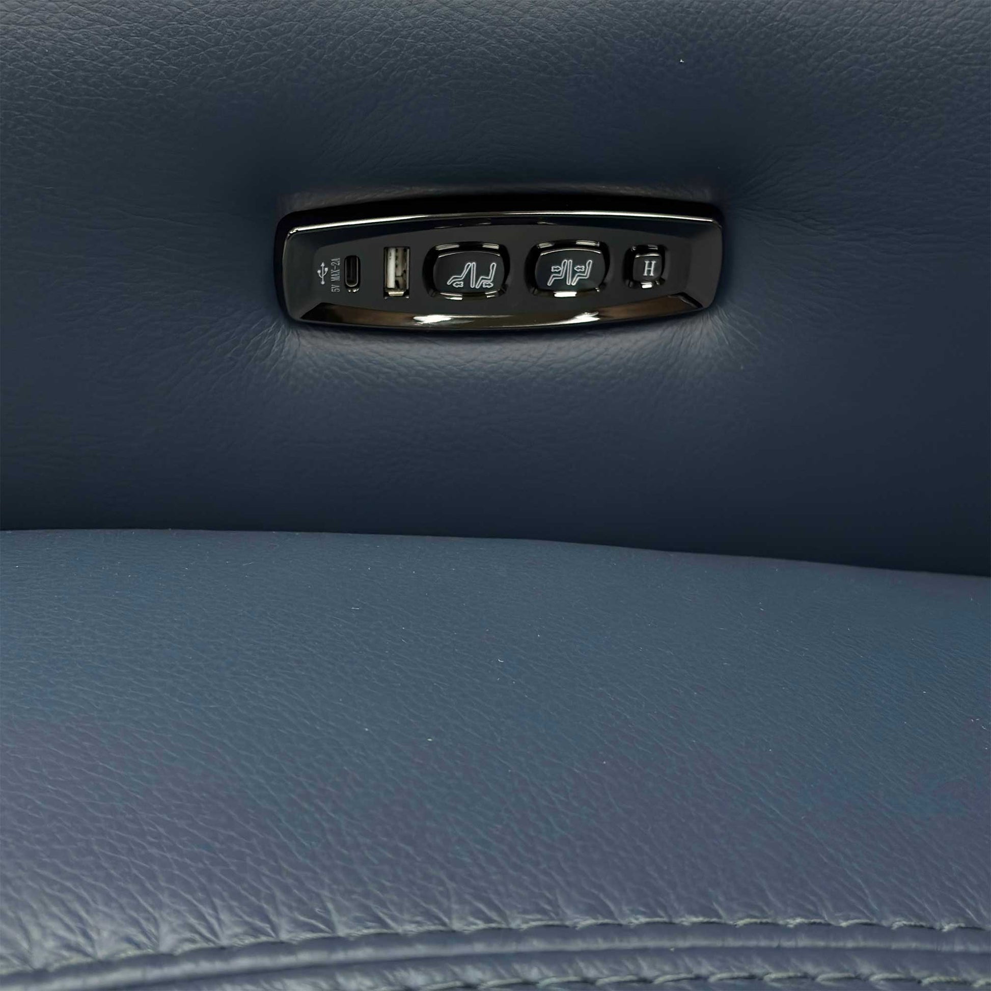 Close-up on the control panel button, likely showing the controls for the power recline and power headrest.
