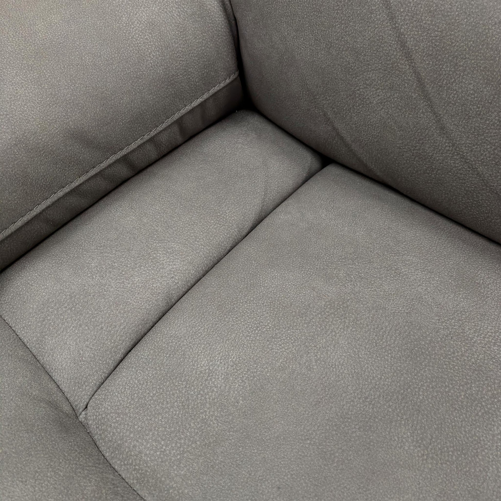 Close-up of the 'Cinemax' sofa showing the plush, padded armrest and the fabric texture.