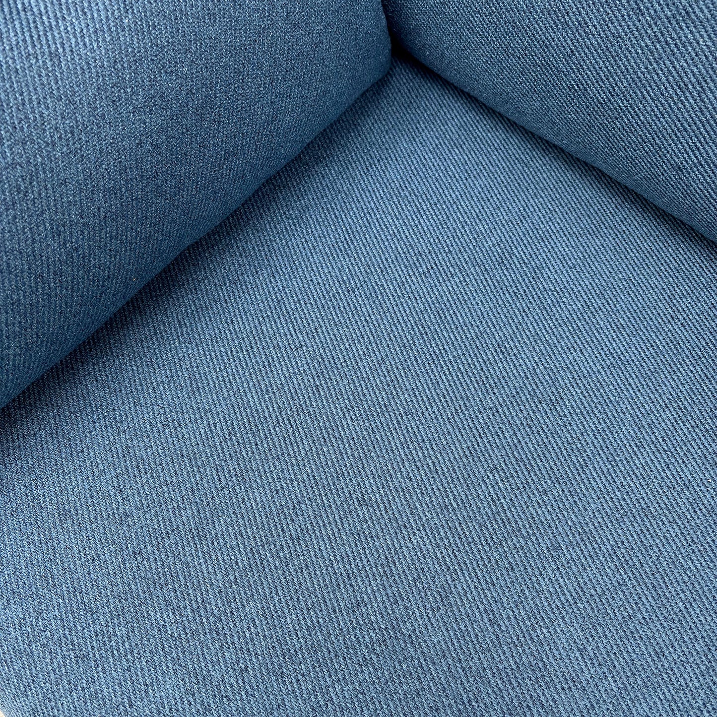 Close-up of the navy blue woven fabric texture on the ‘Wren’ sofa, showing the medium-firm seat cushion and piping detail.