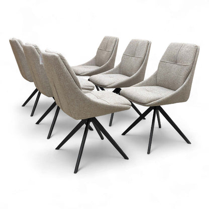 Back view of the ‘Jasmine’ Swivel Dining Chair, showing the smooth curve of the backrest and the metal leg structure.