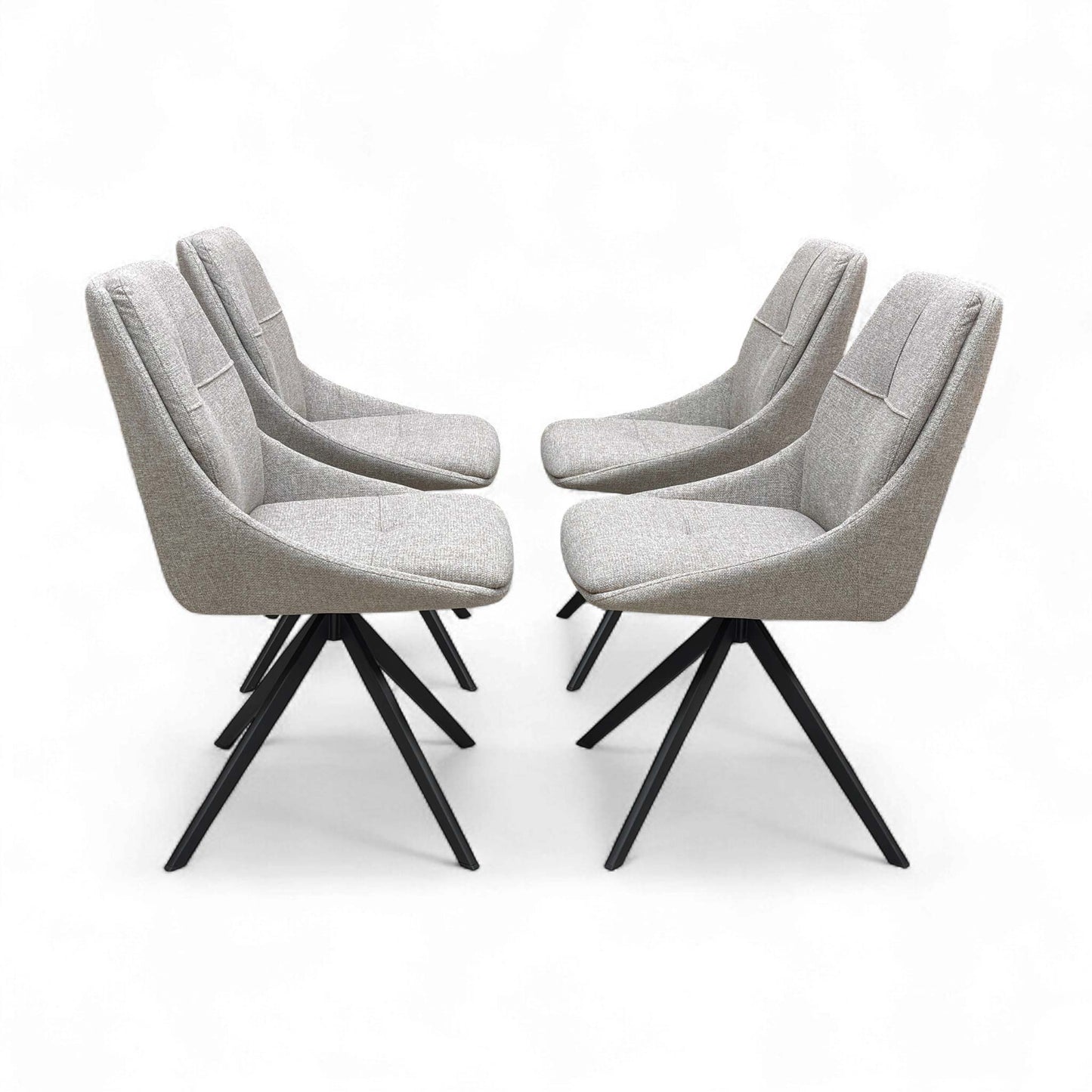 Four chairs positioned around a light-colored dining table.