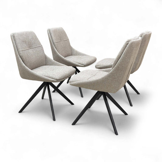 Two ‘Jasmine’ Swivel Dining Chairs in latte fabric, shown side-by-side, emphasizing the padded seat and back.