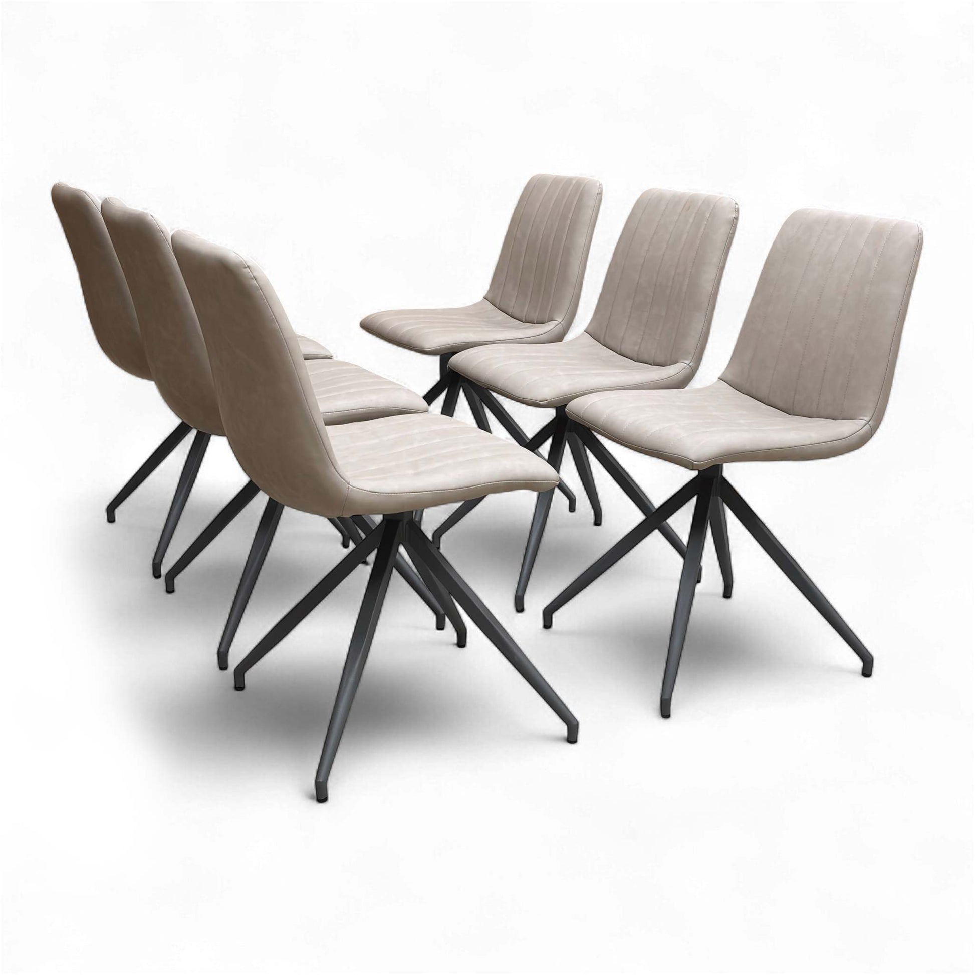 Angled view of the ‘Isaac’ Dining Chair, emphasizing the contemporary metal frame and the padded taupe faux leather seat.