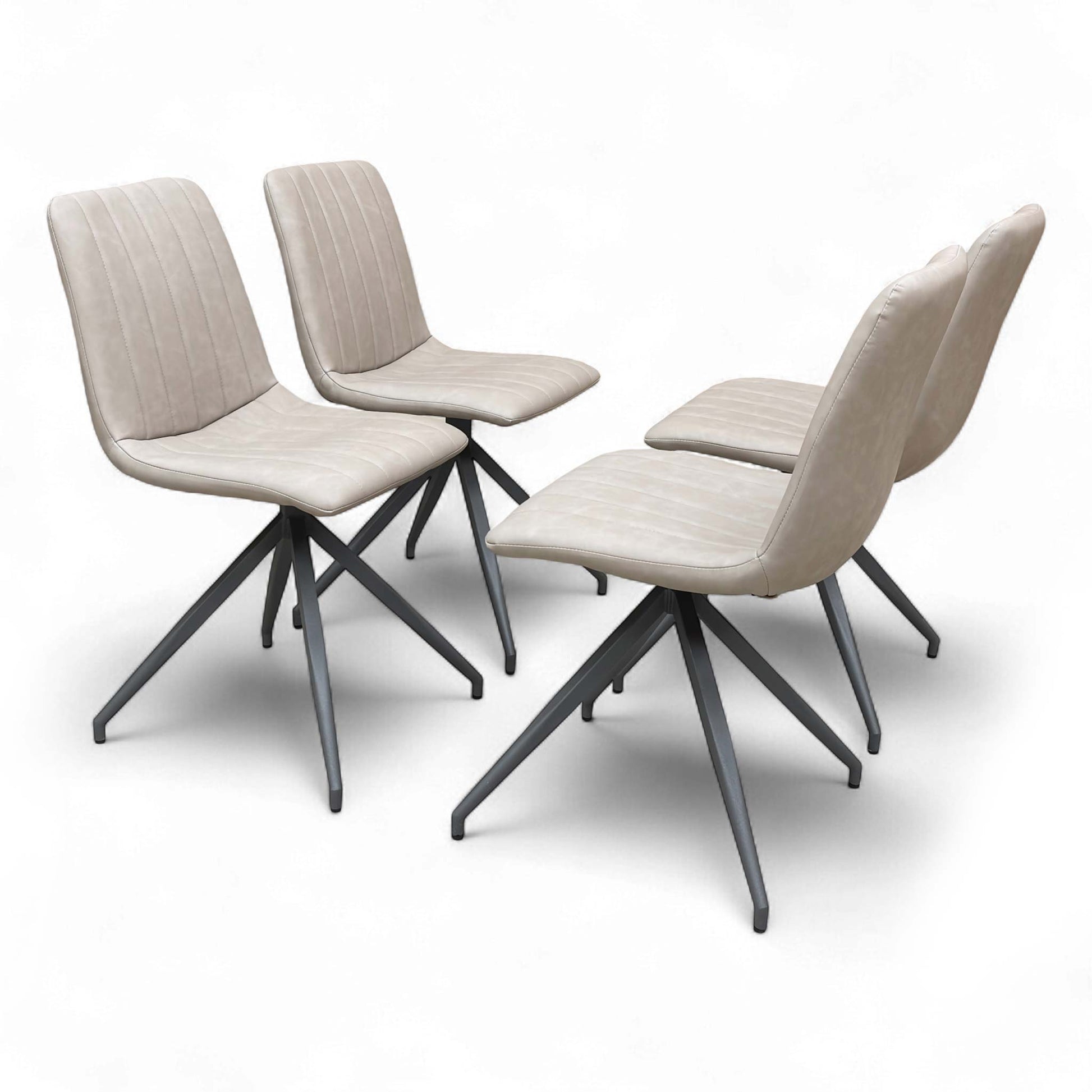 Angled view of the ‘Isaac’ Dining Chair, highlighting the contemporary metal leg structure and its connection to the upholstered seat.