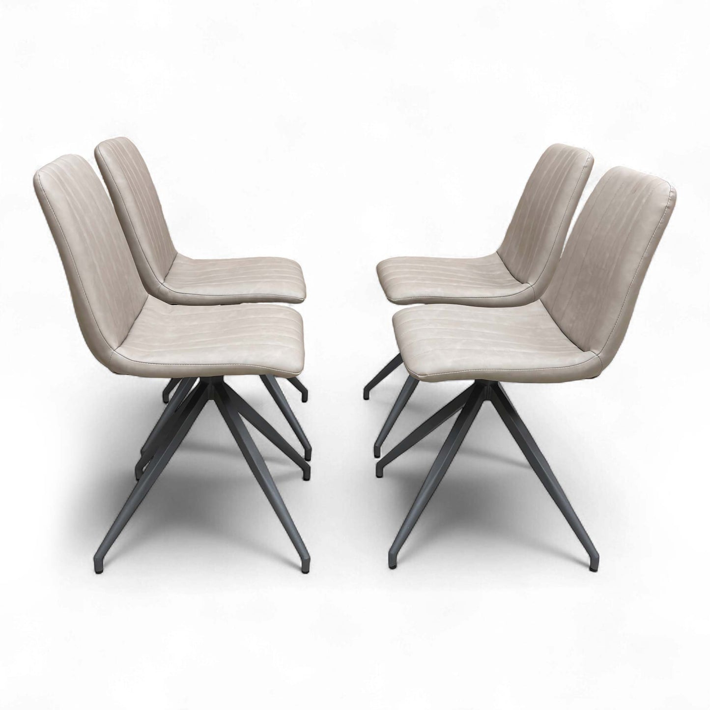 Four chairs positioned around a dining table (suggested setting).