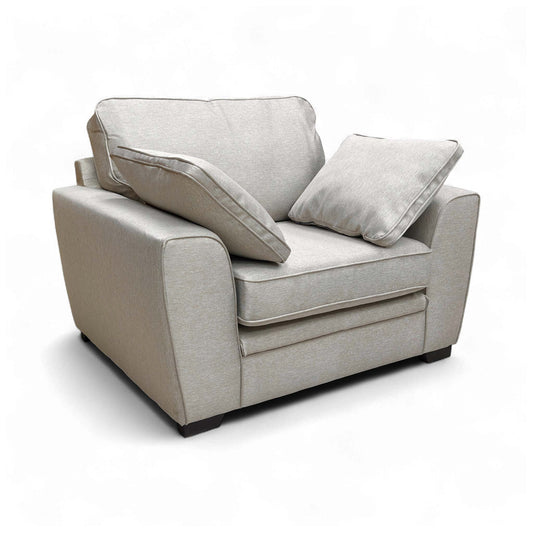 Angled view of the Chalfont Armchair, highlighting the biscuit-colored tight weave fabric and contemporary shape.