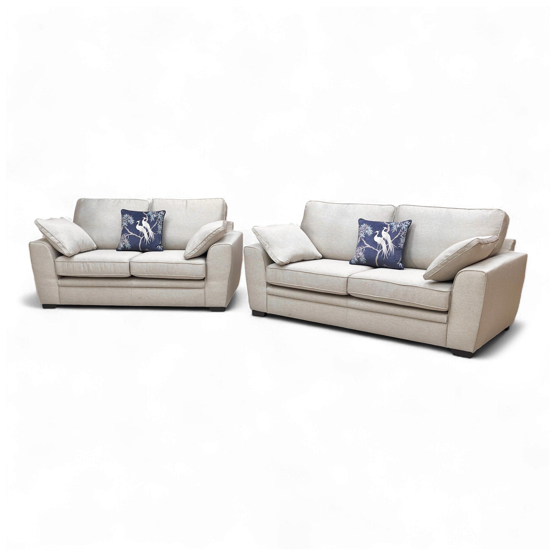 Angled shot of the sofa set, displaying the depth of the seating and the small, dark wooden legs.