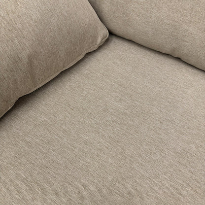 Detailed close-up of the Novak Biscuit soft tight weave fabric, illustrating the upholstery texture and the design of the sloped armrest.