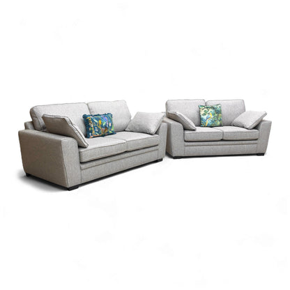 Angled shot of the sofa set, showing the depth of the seating and the modern wooden legs.