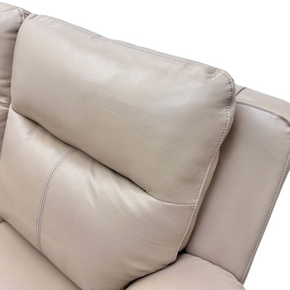 Detailed close-up of the high-quality cream leather upholstery and contrast stitching, highlighting the medium firmness level and pad arm style.