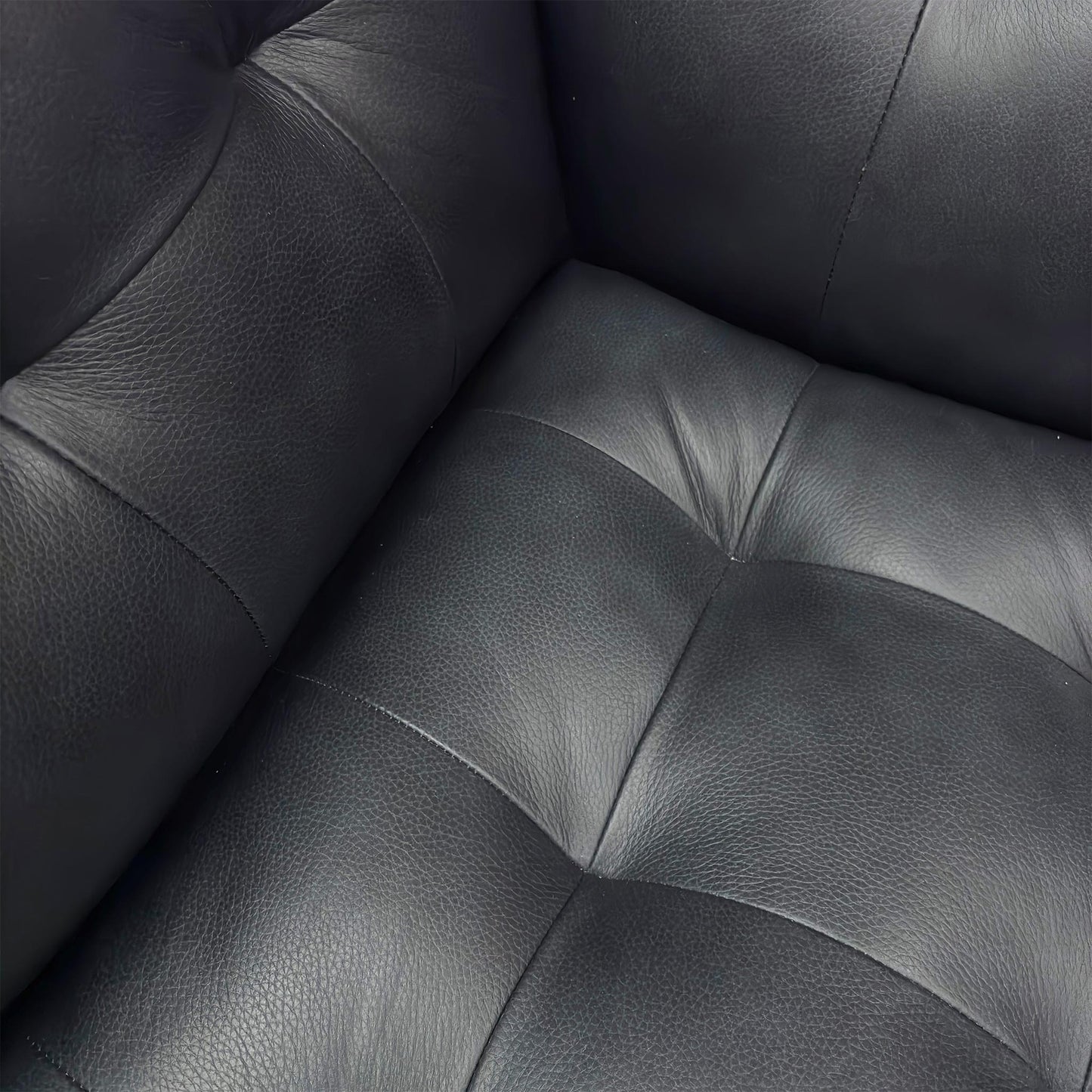Close-up view of the 'Rene' Leather Armchair, showing the padded seat and back cushions.
