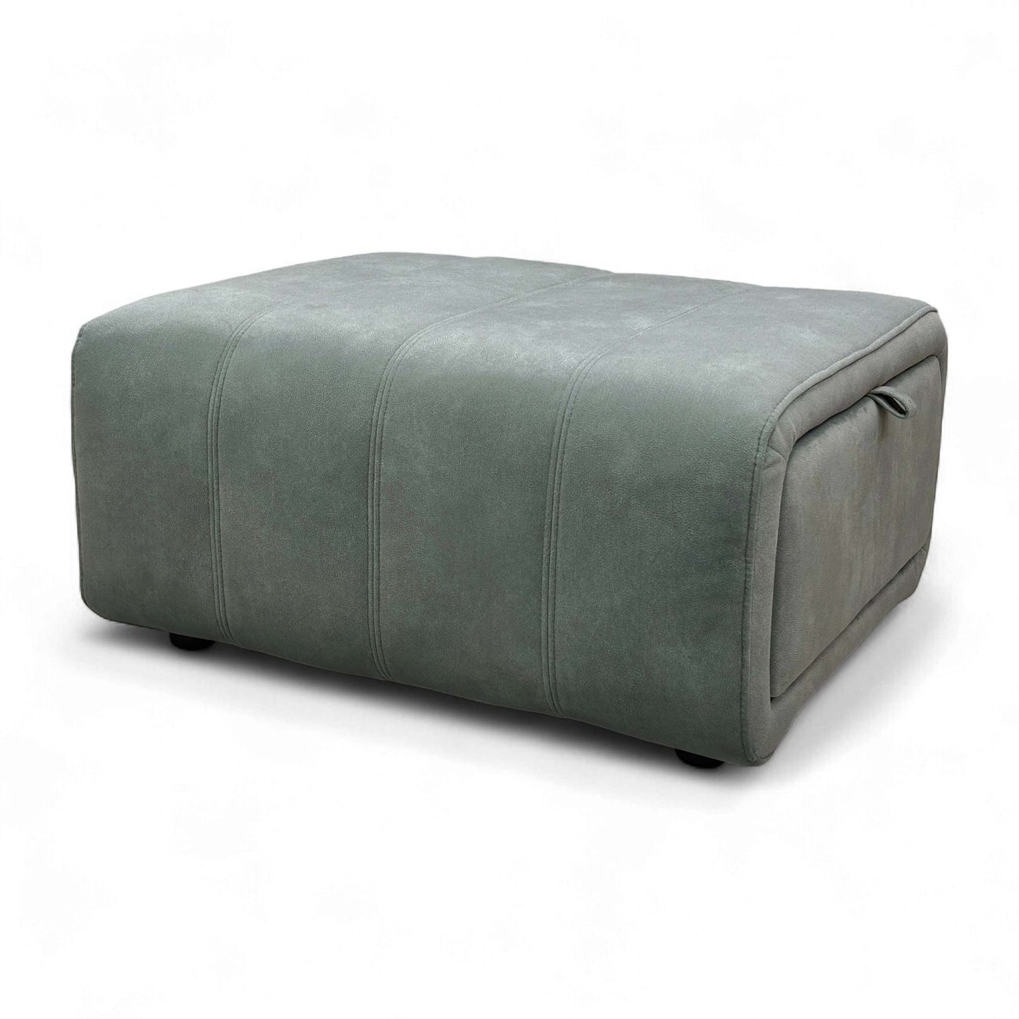 Low-angle shot of the green velvet footstool, emphasizing the material's sheen and its sturdy base.