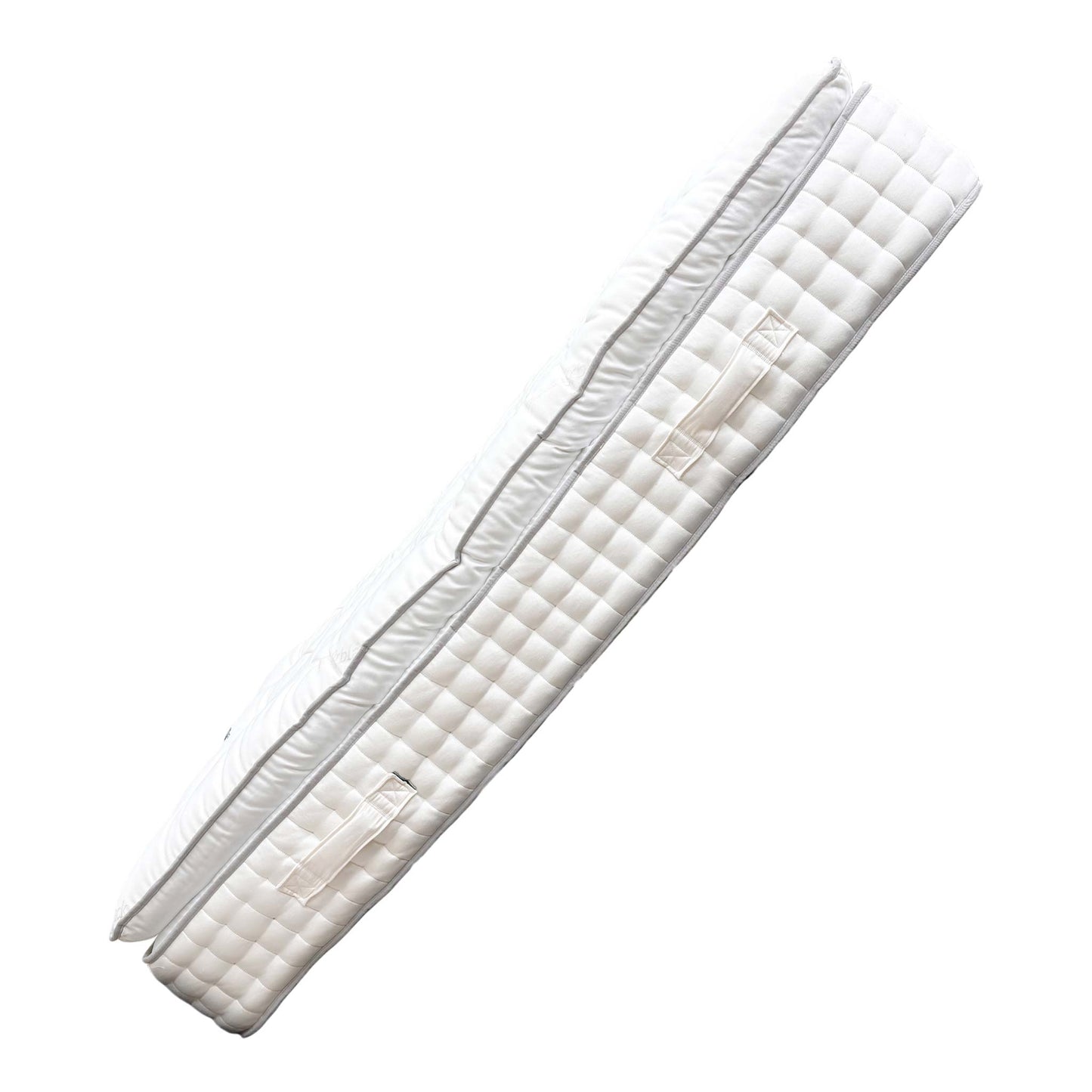 Angled view of the Cawthorne Cashmere mattress, highlighting its substantial 36 cm thickness, durable side borders, and clean, white fabric ticking.